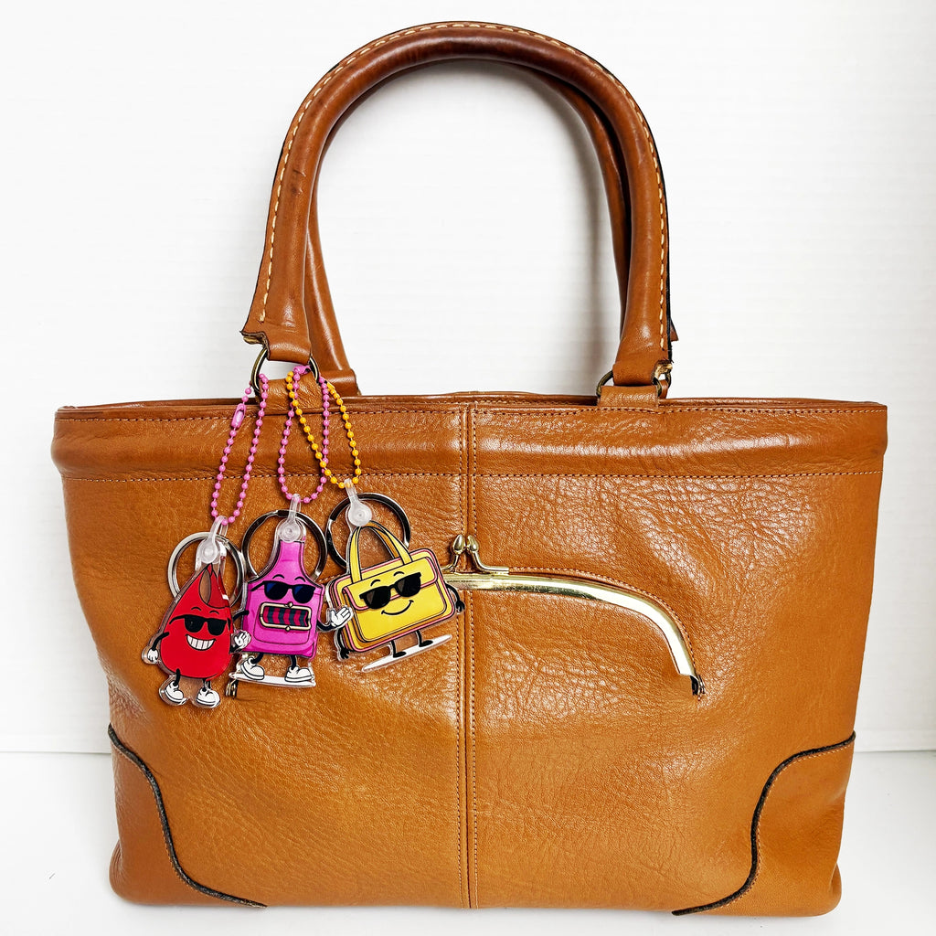 Charmlingz Slingy bag charm key chain with BB and Ms Saffe charm key chain on vintage brown handbag for scale.