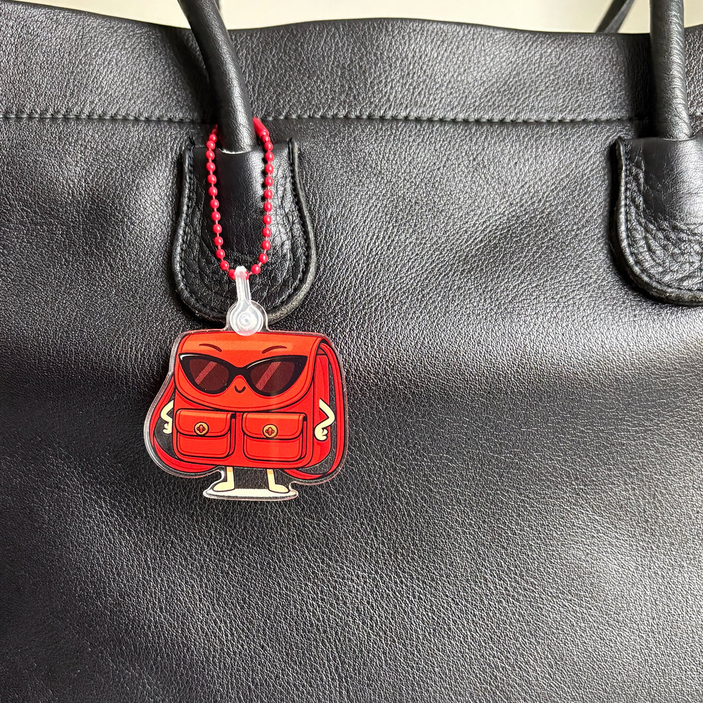 Close up of Charmlingz Posty on vintage bag.