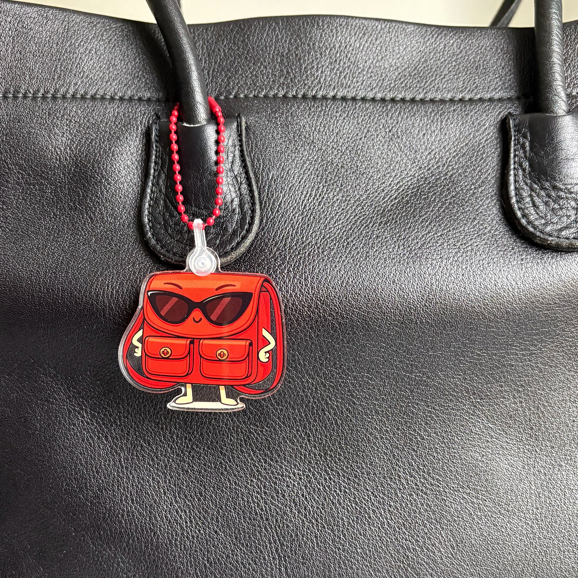 Close up of Charmlingz Posty on vintage bag.