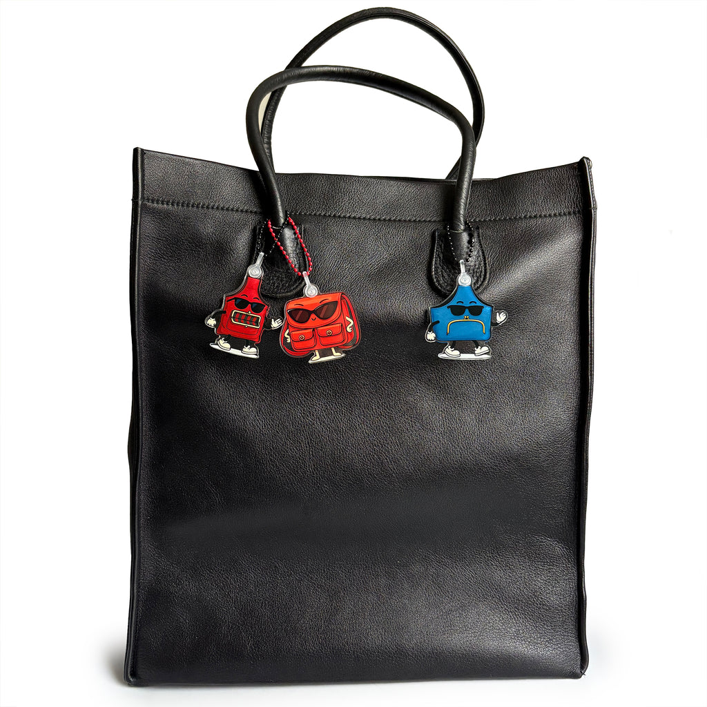 Charmlingz Slingy Red bag charm key ring with Posty and Muffy bag charms on vintage tote bag