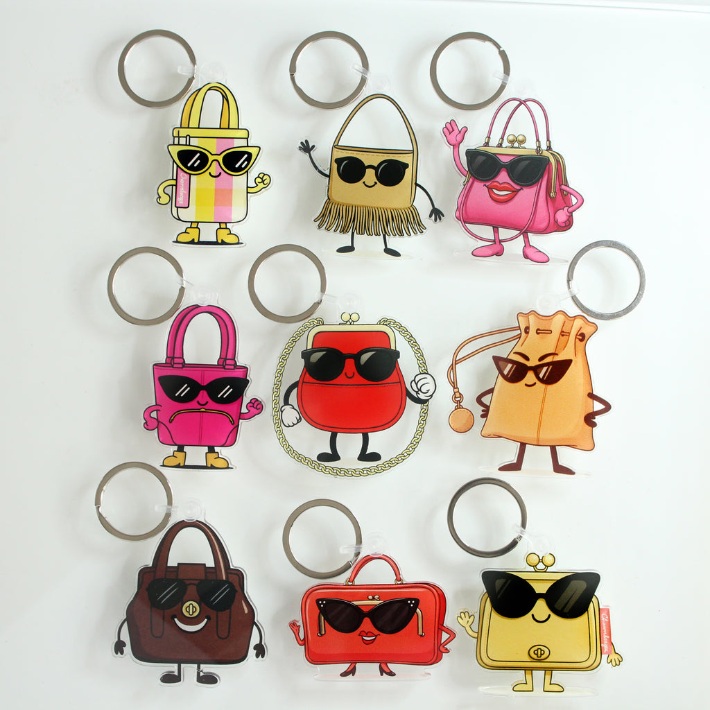 Set of cartoon handbag bag charms keychains with sunglasses on a white background