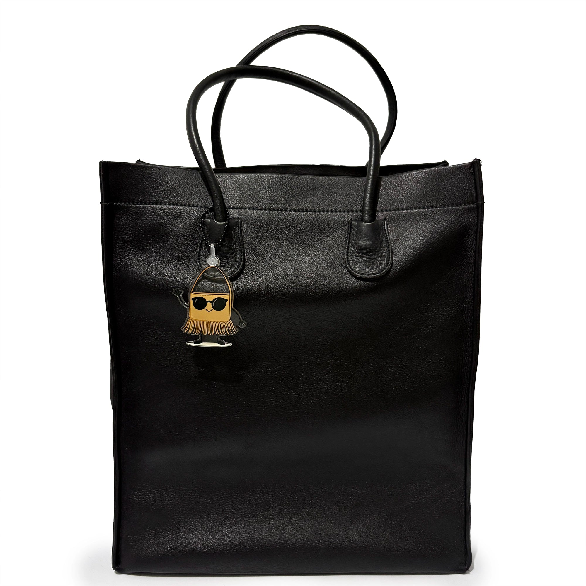 Black tote bag with a unique charm on a white background