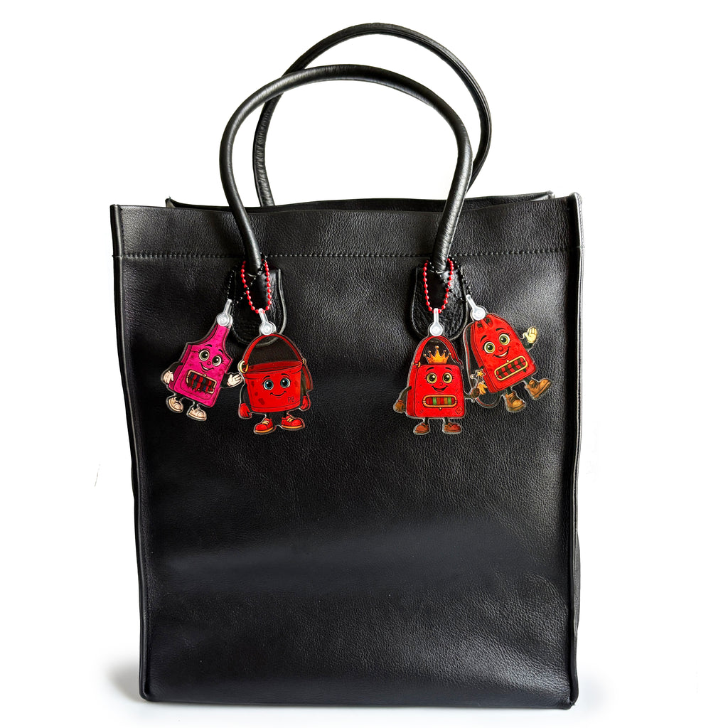 Black vintage tote bag with ReLuvable bag charms Fee Dee Slingy PB and Duffy.