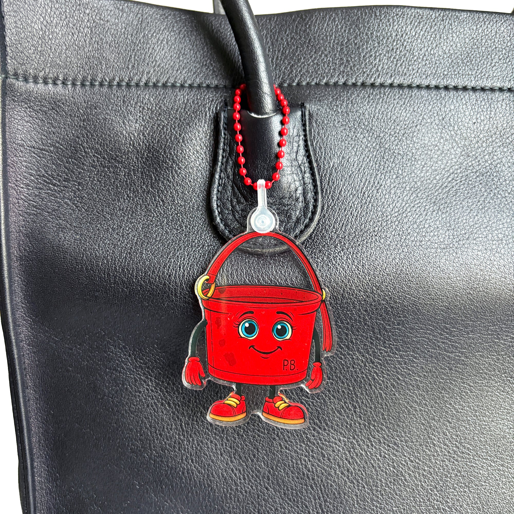 Close up of ReLuvable PB bag charm on vintage tote bag