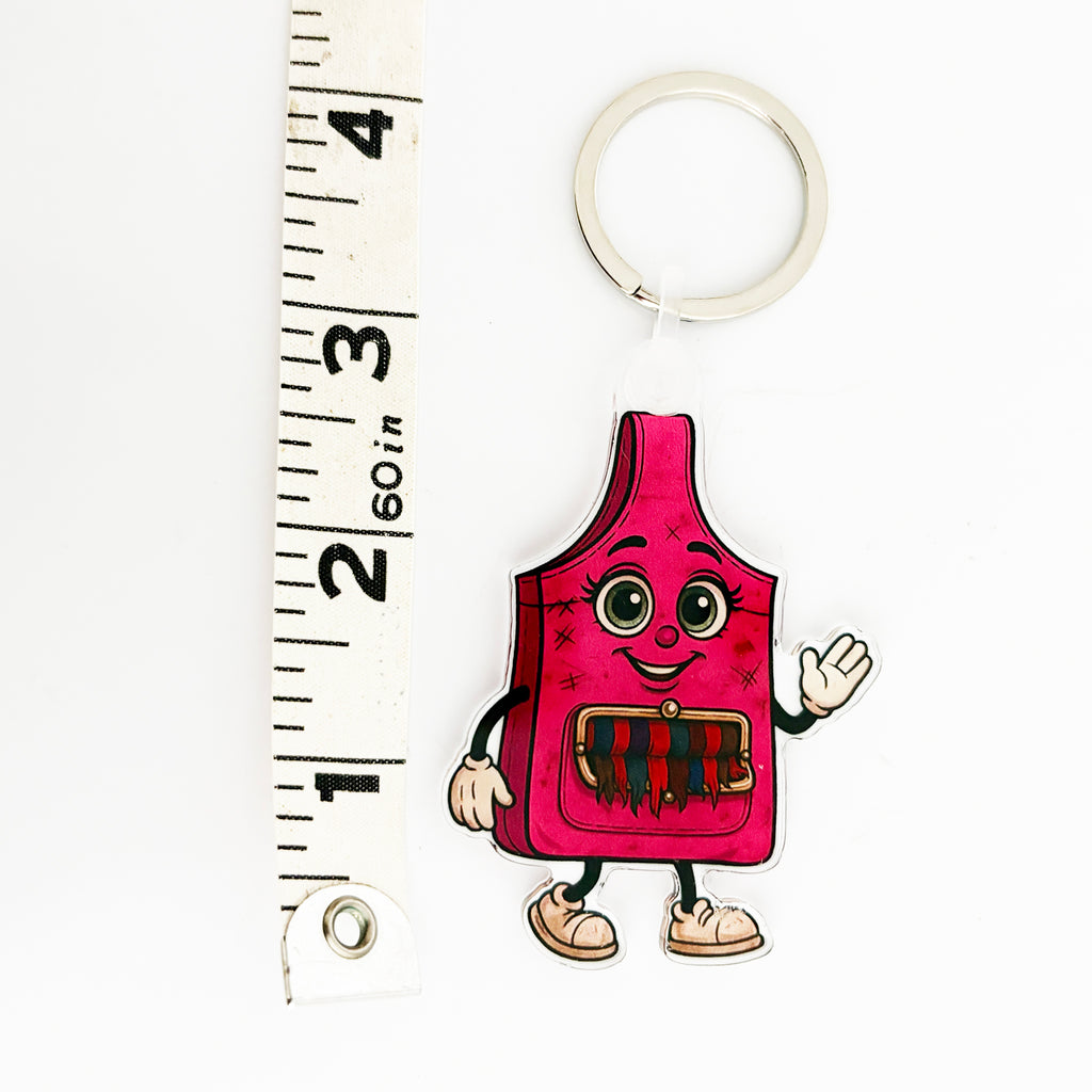 ReLuvable Slingy pink bag charm with distressed look and fringe pocket shown next to ruler for scale.